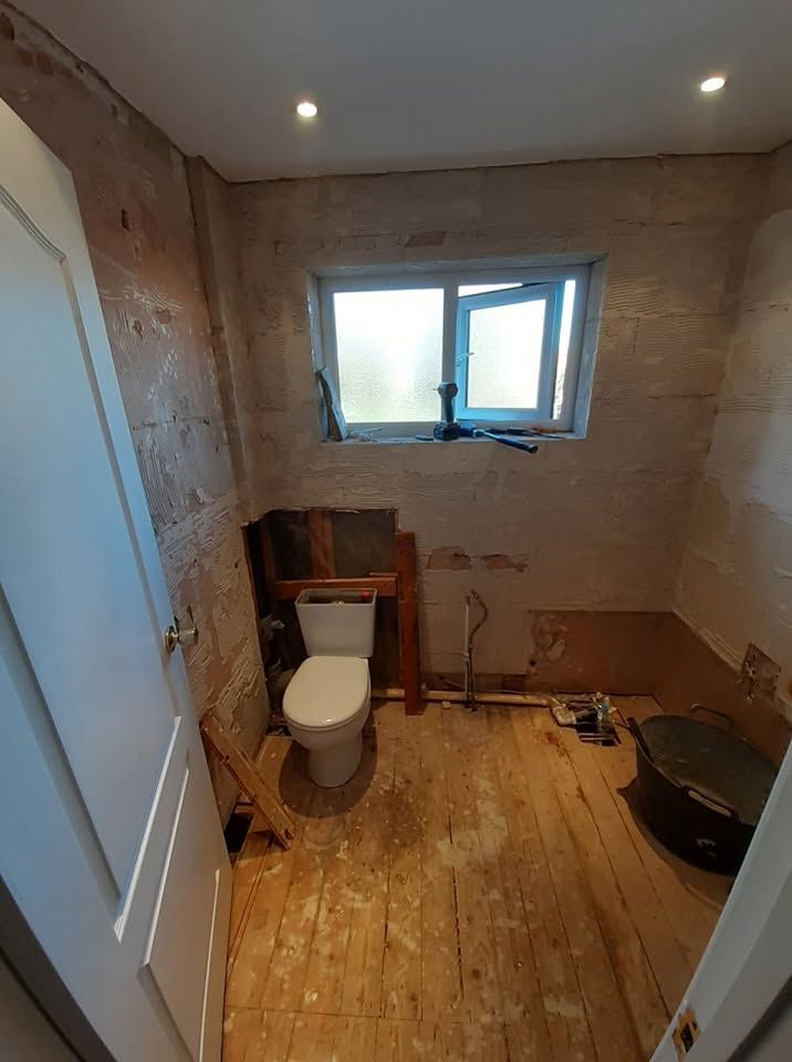 Bathroom during renovation with exposed plasterboard