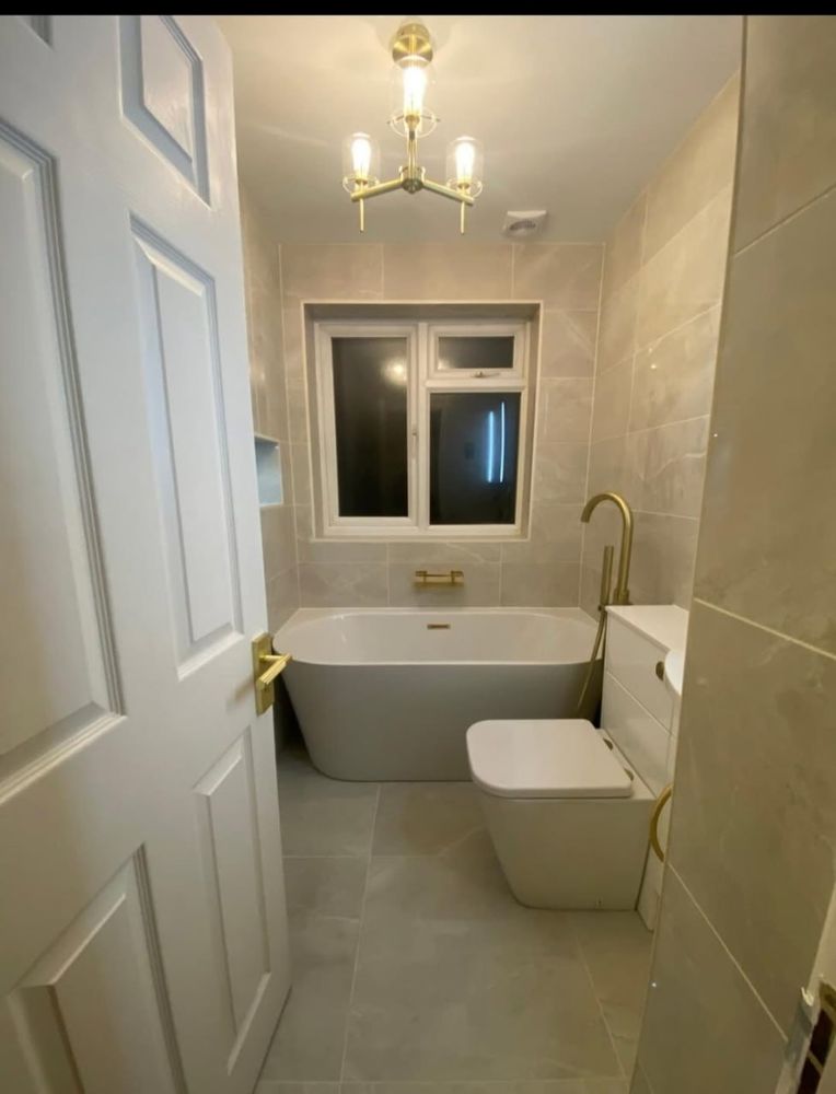 Glass enclosed shower with tiled walls